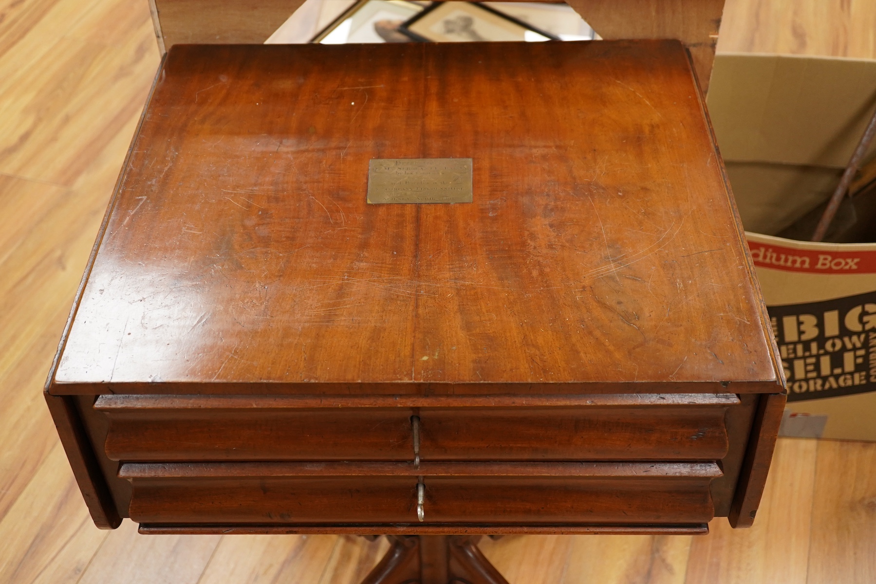 A mid 19th century mahogany pedestal Pembroke table, with inset brass plaque engraved; ‘Presented to Qtr. Master Sgt. Ed. Rainey by his Comrades the Officers, Non-Commissioned Officers and Privates of the 7th Company Lin